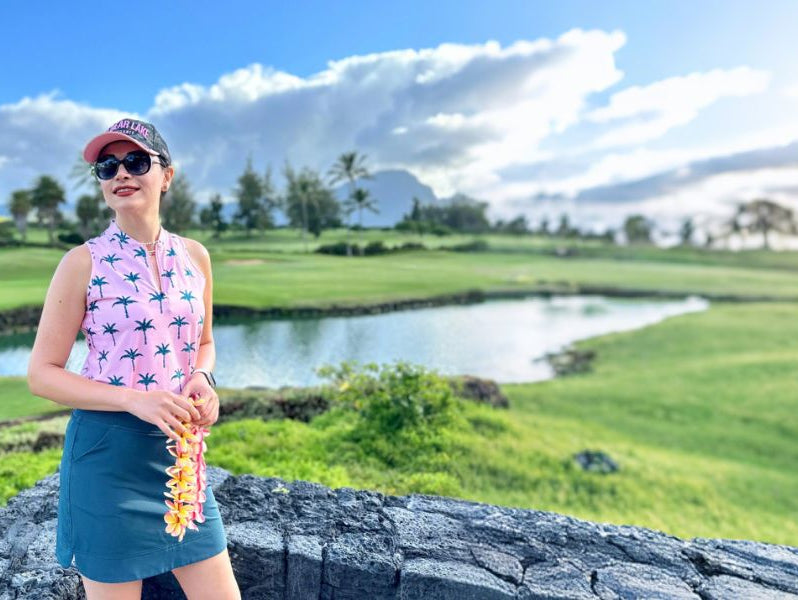 Woman wearing pink sleeveless Hawaiian shirt
