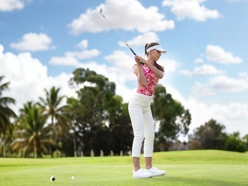 Women wear bright pink sleeveless printed golf shirts to play golf
