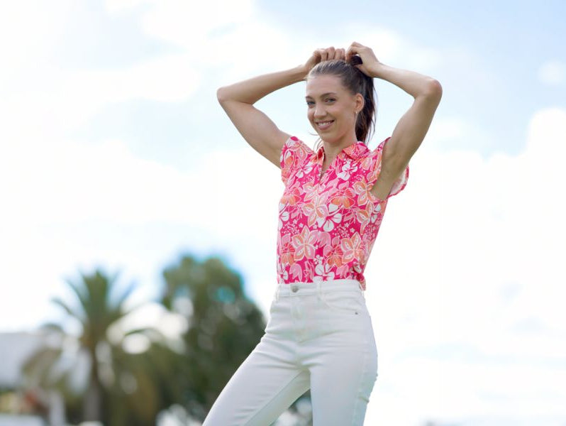 Woman wearing sleeveless pink printed polo shirt