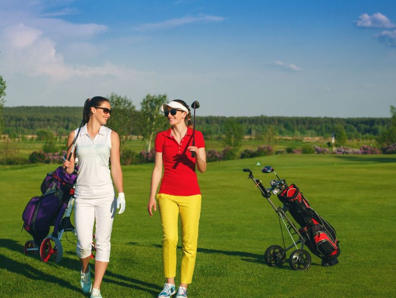 Two ladies wearing golf attire to play golf in the evening